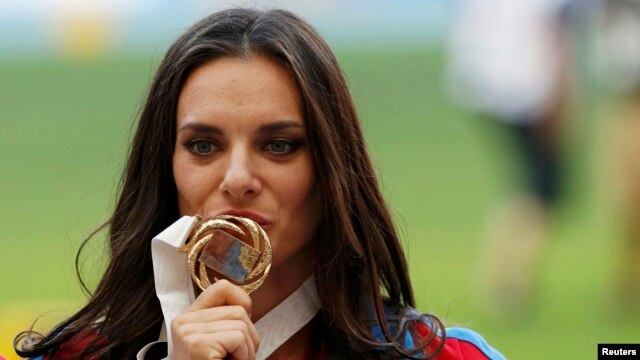 Russia's Yelena Isinbayeva kisses her gold medal at the women's pole-vault victory ceremony during the IAAF World Athletics Championships in Moscow on August 15.