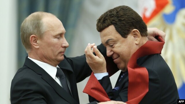 Russian President Vladimir Putin awards a medal to singer Iosif Kobzon (right) during a ceremony in the Kremlin in Moscow in August 2012. 