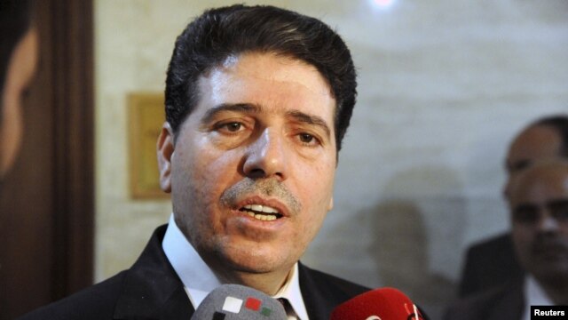 Syrian Prime Minister Wael al-Halqi says the government is not planning to surrender at talks in Geneva.