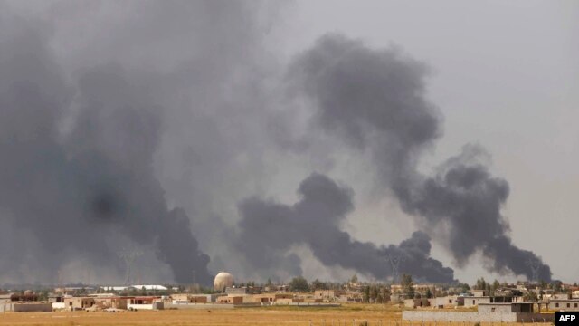 Smoke rises above the Baiji area as Iraqi pro-government forces take part in an operation to retake it from Islamic State militants. 