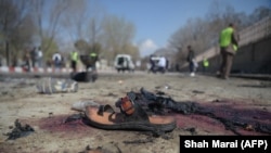 A sandal is seen lying on the ground along a road at the site of a suicide bombing in Kabul on March 21.