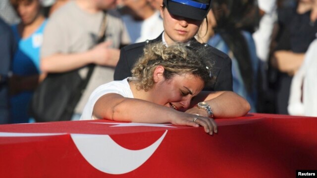 A relative mourns over the coffin holding the body of police officer Nedip Cengiz Eker, killed during the coup attempt, during a funeral ceremony in Marmaris.