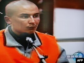 A TV grab shows one of six defendants speaking during a capital trial in October over July's ethnic unrest in Xinjiang.