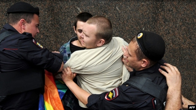 Russian riot policemen detain a gay rights activist during an unauthorized rally in central Moscow earlier this year.