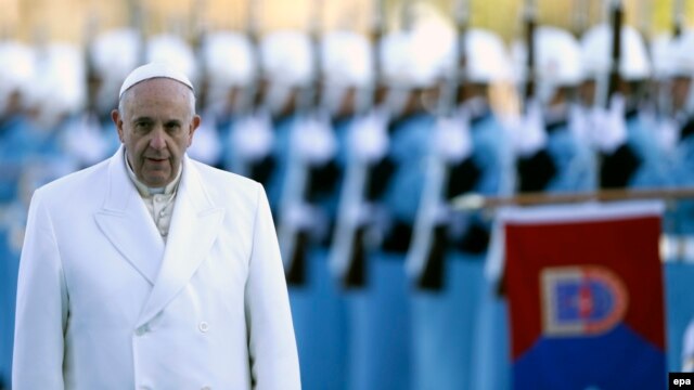 Pope Francis reviews a honor guard during a welcoming ceremony at the presidential palace in Ankara, Turkey.