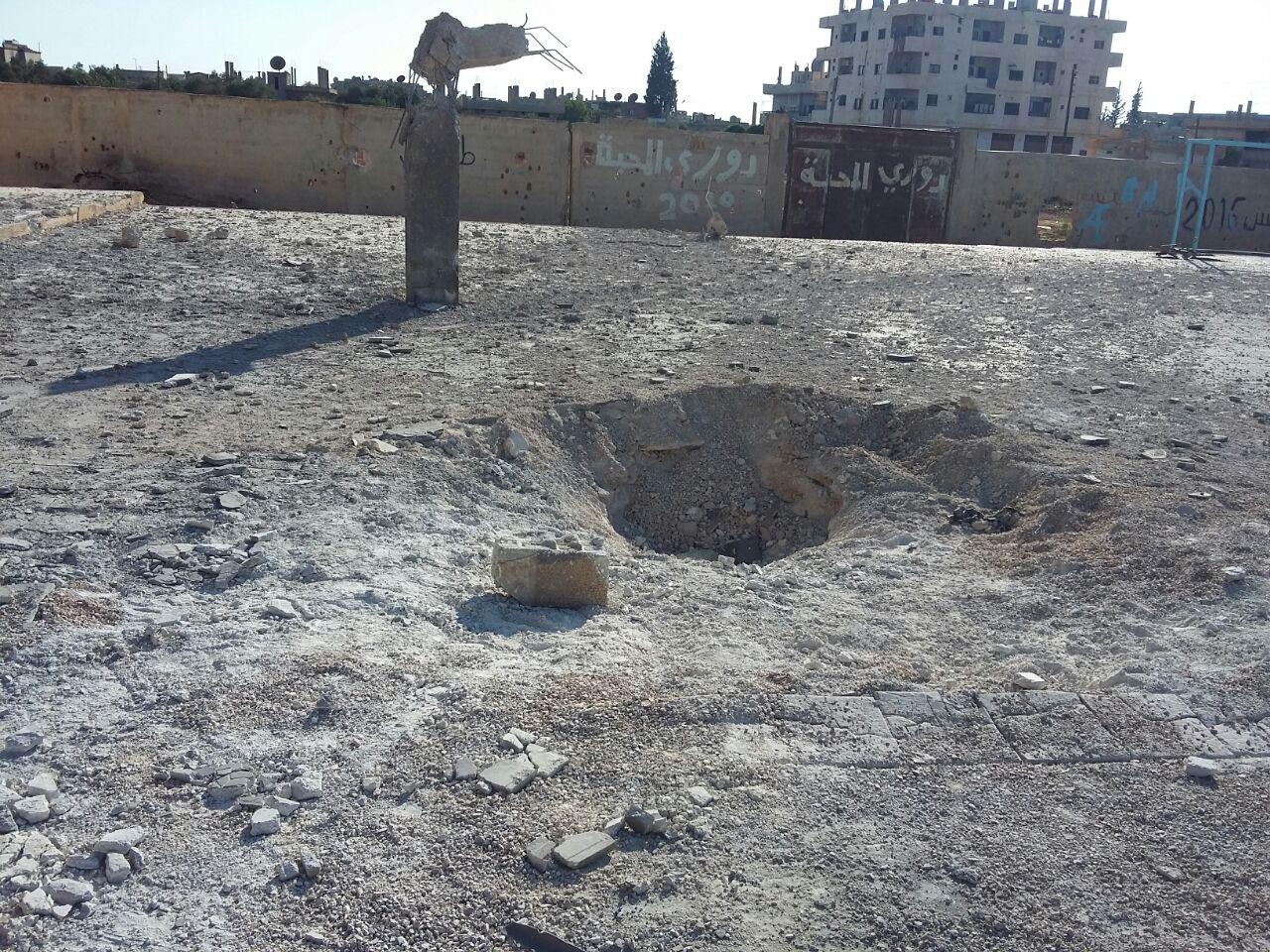 The impact crater in the Martyr Kiwan school courtyard from a Syrian-Russian airstrike on June 14, 2017. Seven of the eight casualties, including a child, were from a displaced family and had been sheltering in the school. 