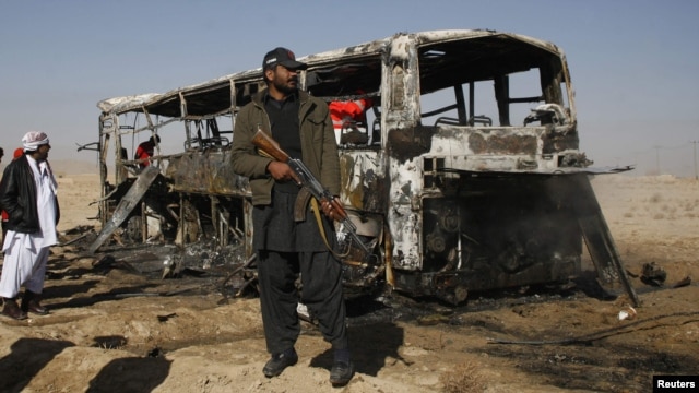 A Pakistani paramilitary soldier stands guard at the site of the bus bombing in Balochistan on December 30.