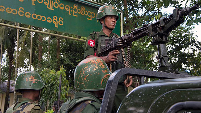 Myanmar soldiers stand guard in Maungdaw township in Myanmar's northern Rakhine state, Sept. 27, 2017.