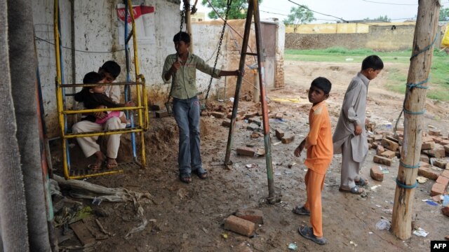 Youngsters play near the house of a Christian girl who was arrested on charges of blasphemy in a low-income slum in Islamabad.