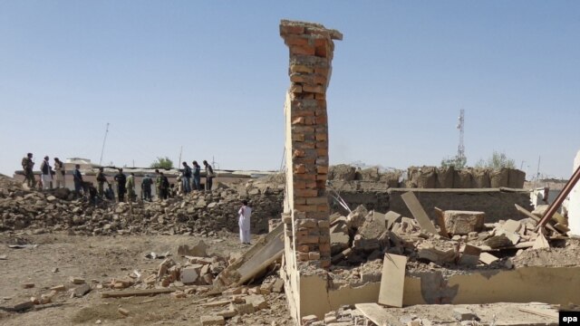 Afghan security officials inspect the site of a suicide bomb blast, in Paktia, September 29, 2014