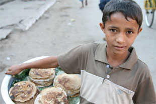 This boy has dropped out of school to support his family by selling pancakes on the streets of Sittwe, early 2008. RFA/ Tyler Chapman