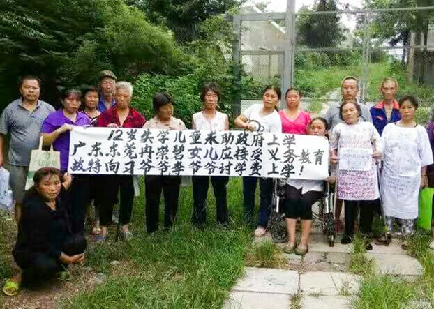 Petitioners whose children have been been denied access to school protest in Beijing's Fengtai District, Aug. 20, 2016.