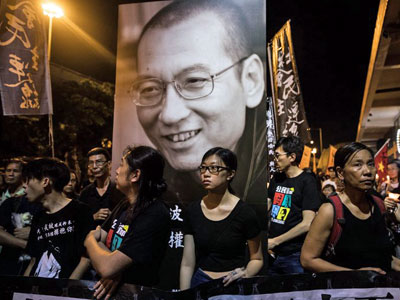 People attend a candlelight march for late Chinese Nobel laureate and pro-democracy dissident Liu Xiaobo in Hong Kong, July 15, 2017.