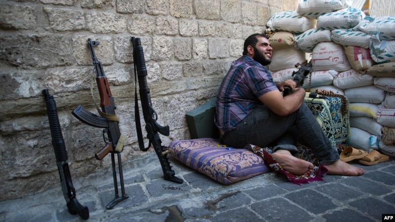 A Syrian rebel fighter mans a checkpoint in the northern city of Aleppo on August 20. 