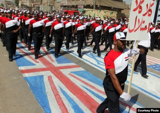 Supporters of Muqtada al-Sadr march in the street and trample on the Israeli, British, and U.S. flags in Baghdad in May.