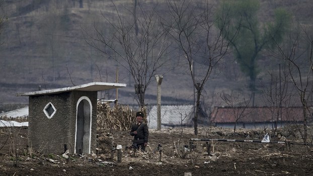A North Korean soldier stands next to a watchtower on the banks of the Yalu river near Sinuiju, April 14, 2017.