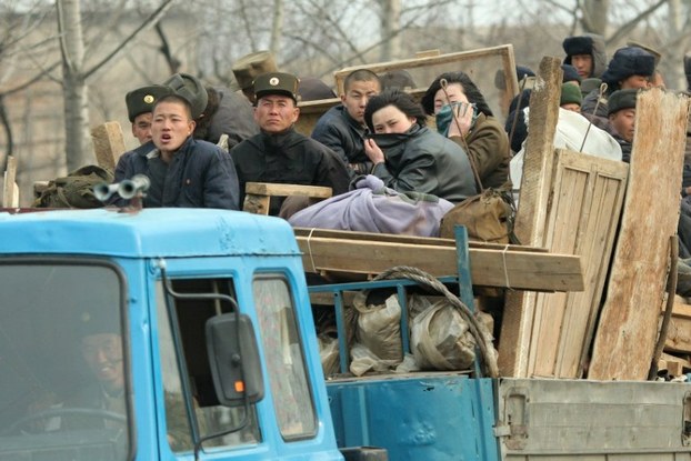 North Korean workers ride in the back of a truck in Pyongyang in a file photo.