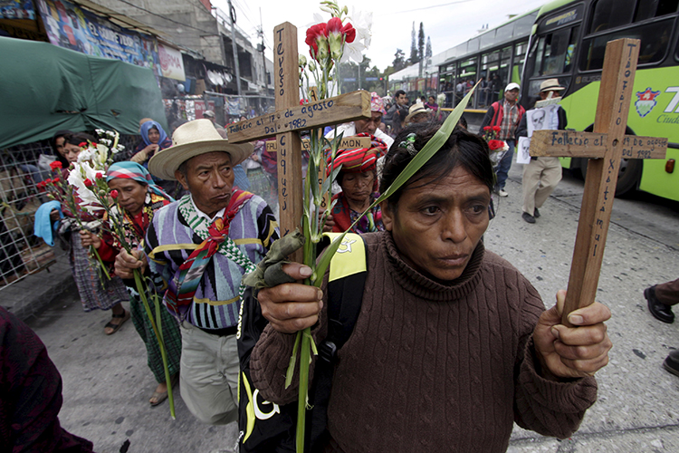 Guatemalans remember those killed in the country's 36-year civil conflict in Guatemala City, February 25, 2016. (Reuters/Josue Decavele)