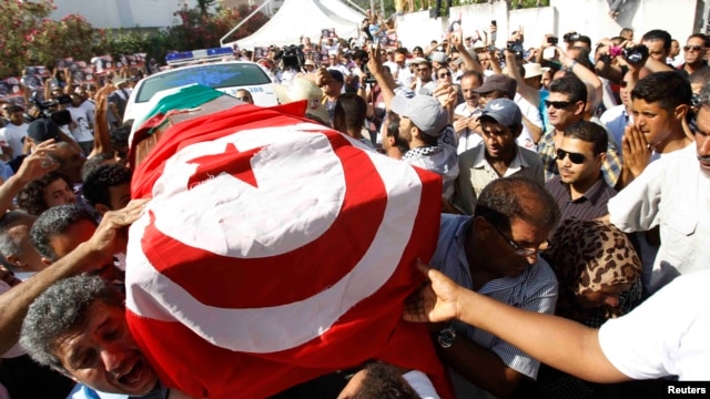 Mourners carry the coffin of slain opposition leader Muhammad Brahmi during his funeral procession in Tunis on July 27. 