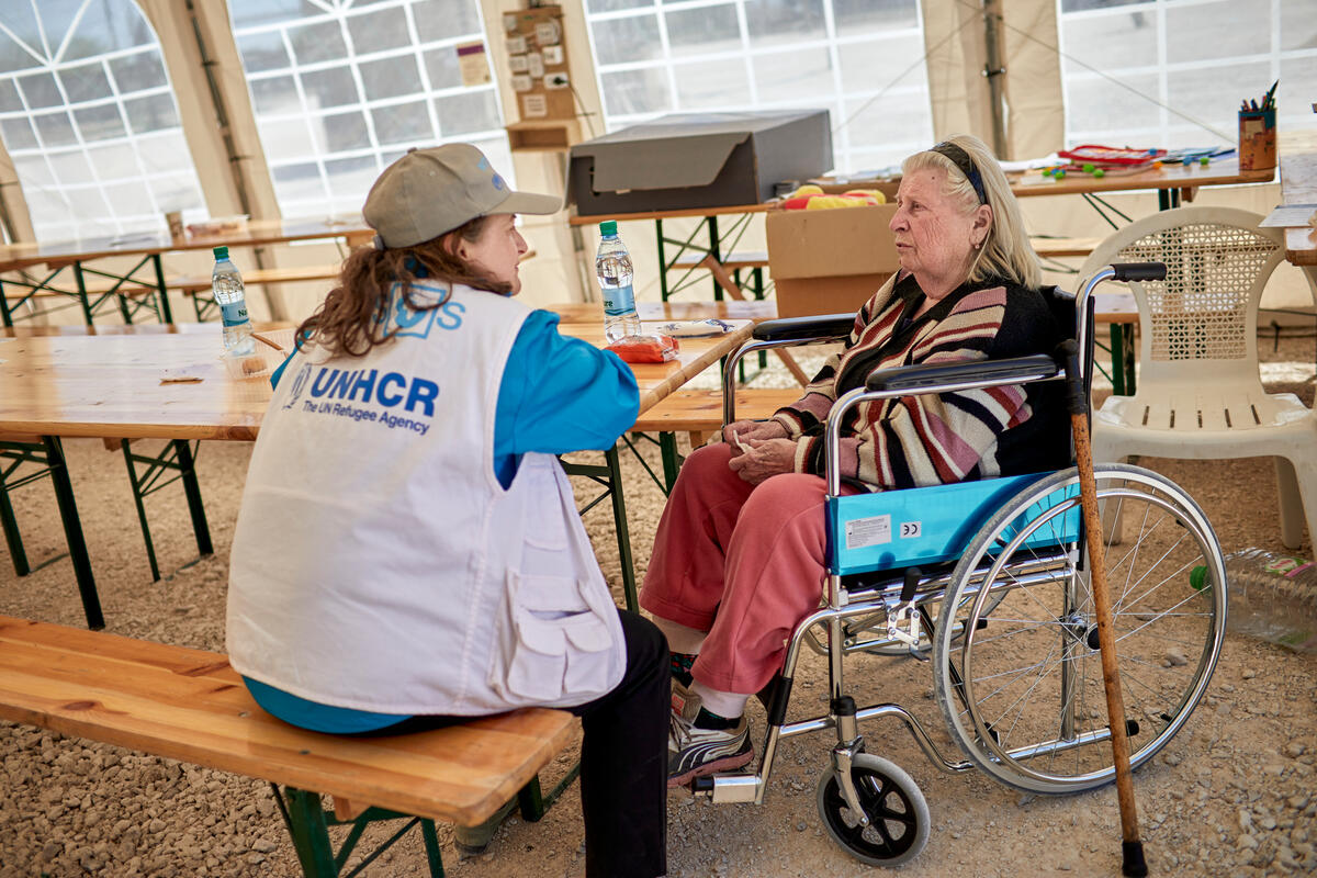 Moldova. Wheelchair-bound woman received by UNHCR at border crossing