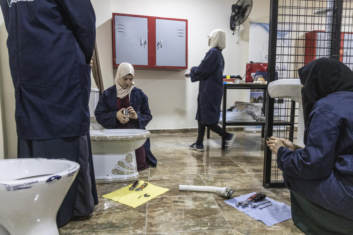 Jordan. Female plumber teaches refugees her trade